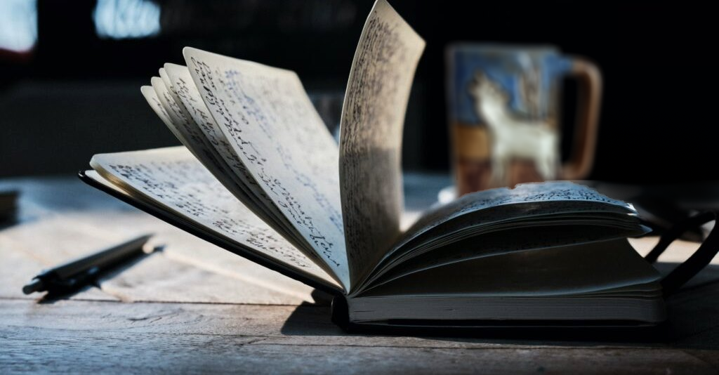 A book opened to pages with writing on it.